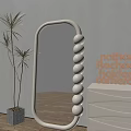 Oval Shaped Mirror With White Spherical Accents Wooden Letters And Palm Plant In Living Room