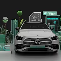 White Mercedes EQE Electric Vehicle Display With Green Plants And Brand Signage