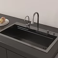Modern Kitchen Sink With Stainless Steel Faucet and Plate of Apples on Black Countertop