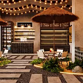 Outdoor Restaurant Design With Straw Umbrellas String Lights Stone Walls And Green Plants