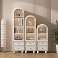 Three Connected Arched Top Bookcase With Drawers Books Decor Items Floor Lamp And Green Plant