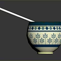 Carved Sculpture Bowl With Blue White Geometric Leaf Patterns And Silver Spoon On Smooth Surface