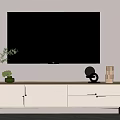 Wooden And White TV Stand With Black Wall Mounted TV And Decorative Plants