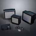 Three Vintage Black Monitors Of Various Sizes With Retro Electronic Accessories