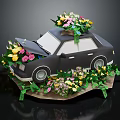 Black Paper Craft Car With Flowers On Roof Inside And Green Leaves Decoration