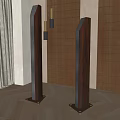 Two Black Columnar Decorative Objects In Interior With Wooden Slat Wall And Green Plant