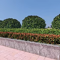 Well Trimmed Round Shrubs With Low Red Green Bushes Stone Wall And Red Brick Pavement