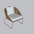Modern Outdoor Wicker Chair with White Cushion and Curved Metal Frame Design