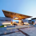Modern Illuminated Residential Building Exterior With Extended Roof And Landscaped Gardens And Stone Steps