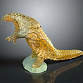 Golden Pangolin Sculpture Standing on Green Base With Detailed Scales and Lifelike Posture