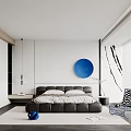 Modern Bedroom Interior Design With White Walls Blue Circular Artwork Black Bed And Accent Chair