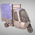Vintage Three Wheeler Tricycle With Blue Tarpaulin Covered Cargo Bed And Weathered Metal Body