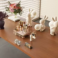 Elegant Perfume and Cosmetics Display on Wooden Table with Rabbit Figurines and Flowers