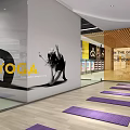 Spacious Fitness Studio with Yoga Mats Wooden Floors Glass Walls Ceiling Lights and Orange Decorations