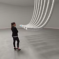 Hanging Silver Tubes Art Installation With Circular Ends And Blue Sphere In Indoor Space