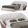 Modern Double Bed Design With Curved Upholstered Headboard Plaid Pillows And Tasseled Blanket