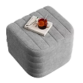 Beige Striped Ottoman With Book Glass Of Drink And Eyeglasses For Living Room Decor