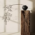 Black Vase With Twigs And Small Berries On Wooden Pillar Against Light Wall With Shadows
