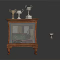 Wooden Display Cabinet with Glass Door Trophies on Top and One Trophy Fallen on Floor