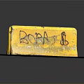 Yellow Road Barrier With Graffiti Featuring BOBA Text And Symbol On Concrete Ground
