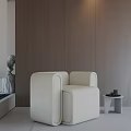 Beige Modern Leisure Chair With Small Side Table And Brown Wall Background