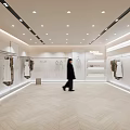 Fashion Clothing Store Interior Featuring Bright Lighting Herringbone Floor Displayed Clothes And Person Walking