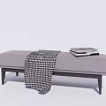 Gray Upholstered Ottoman Footstool With Black Wooden Legs Houndstooth Blanket And Stacked Books