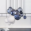 Multiple White Spherical Pendant Lights Hanging Against Light Colored Background 3d model