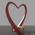 Heart Shaped Red Art Installation With Orange Stool And Smooth Curved Design