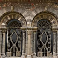 Historic Architectural Details With Arched Doorways And Intricate Iron Grilles