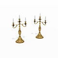 Decorative Golden Candelabras With Multiple Candle Arms And Ornate Bases
