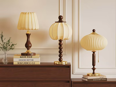 Three Elegant Table Lamps On Wooden Cabinet With Books And Green Plant 3d model