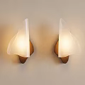 Two Modern Wall Lamps With Transparent Shade And Brown Base On Beige Wall