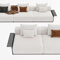 Modern White Three Seater Sofa With Black Armrests Multiple Pillows And Brown Blanket