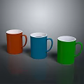 Three Colorful Mugs Orange Blue Green With Handles On Dark Surface