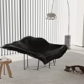Modern Black Chaise Lounge With Small Wooden Stool Cat On Rug And Floor Lamp