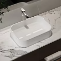 Elegant White Washbasin on Marble Countertop with Modern Chrome Faucet Design