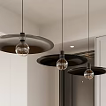 Three Modern Pendant Lights With Black Shades And Glass Bulbs In Kitchen Interior