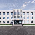 Modern Office Building With White Exterior Large Windows Front Entrance Steps And Green Plants