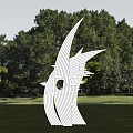 White Streamlined Sculpture With Curved Lines On Green Lawn Among Trees Under Blue Sky