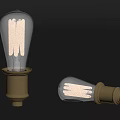 Vintage Light Bulbs With Clear Glass Gold Base And Filaments On Dark Background