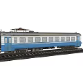 Blue And White Passenger Train Carriage On Railroad Tracks Model