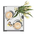 Two Latte Coffee Cups on White Tray with Yellow Tulips Vase and Macaron Desserts