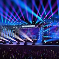 Colorful Concert Stage with Large LED Screen and Audience Waving Light Sticks