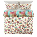 Double Bed With White Frame And Colorful Floral Bedspread And Pillows