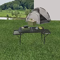 Outdoor Camping Table With Metal Legs For Grassland Use Featuring Laptop Cup And Yellow Fruits
