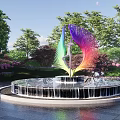 Colorful Feather Shaped Sculpture as Centerpiece in Circular Fountain with Trees and Flowers
