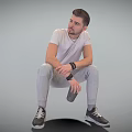 Man Sitting In Gray Sweatpants White T-Shirt Wearing Watch Holding Thermal Cup On Gray Background