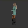 Blonde woman in turquoise dress and gray over-the-knee boots standing against gray background