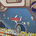 Kindergarten Indoor Play Area With Kids Playing On Climbing Net And Slide